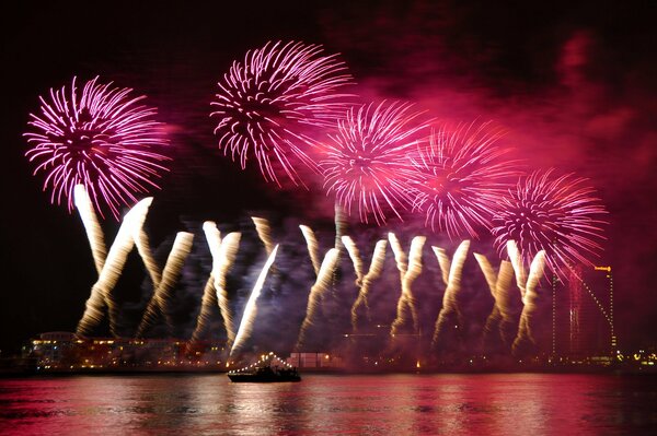 Night fireworks and colorful reflection in the water