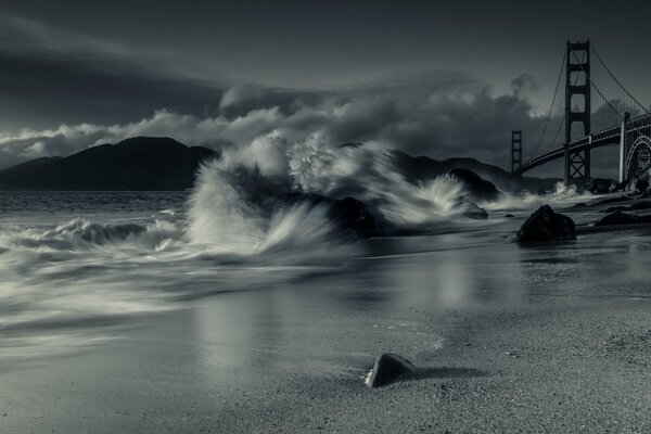 Black and white photo of waves at the bridge in San Francisco