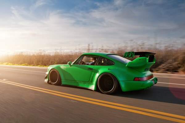 Coche verde porshe a alta velocidad