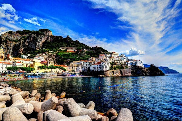 A city on the shore of a bay and a stone beach