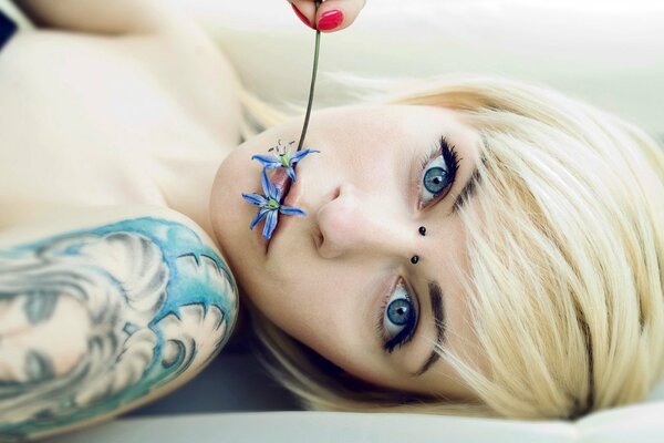 Blonde beauty in tattoos and piercings