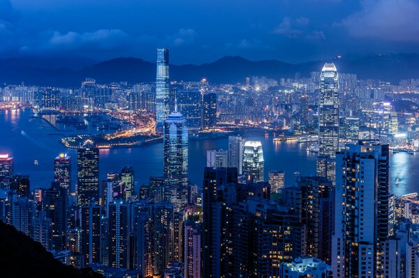 Panorama de nuit, Chine, Hong Kong. Hong Kong port Victoria, vue sur les gratte-ciel dans la nuit. Port Victoria: vue de dessus. Gratte-Ciel Du Port Victoria À Hong Kong. Baie Victoria