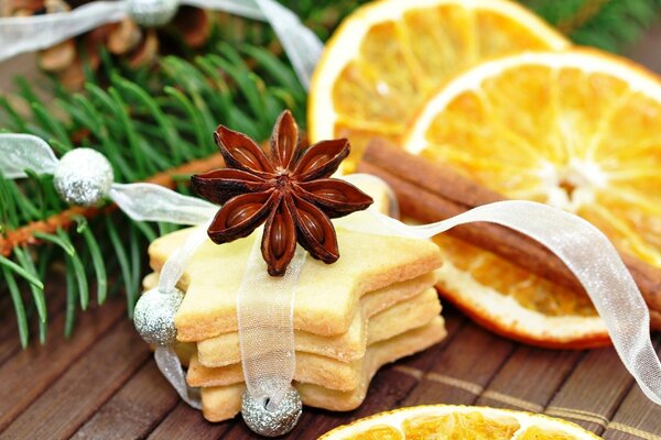 Beautifully decorated cookies on the background of oranges and spruce branches