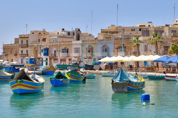 A city on the Mediterranean Sea with boats on the pier