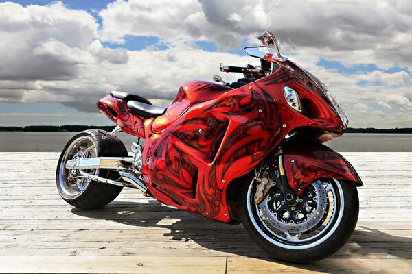 Airbrushing of a red motorcycle with clouds