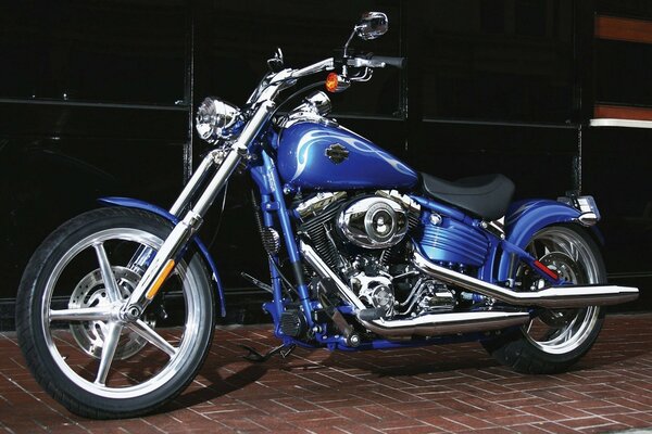 Blue Harley Davidson bike on a black tile background