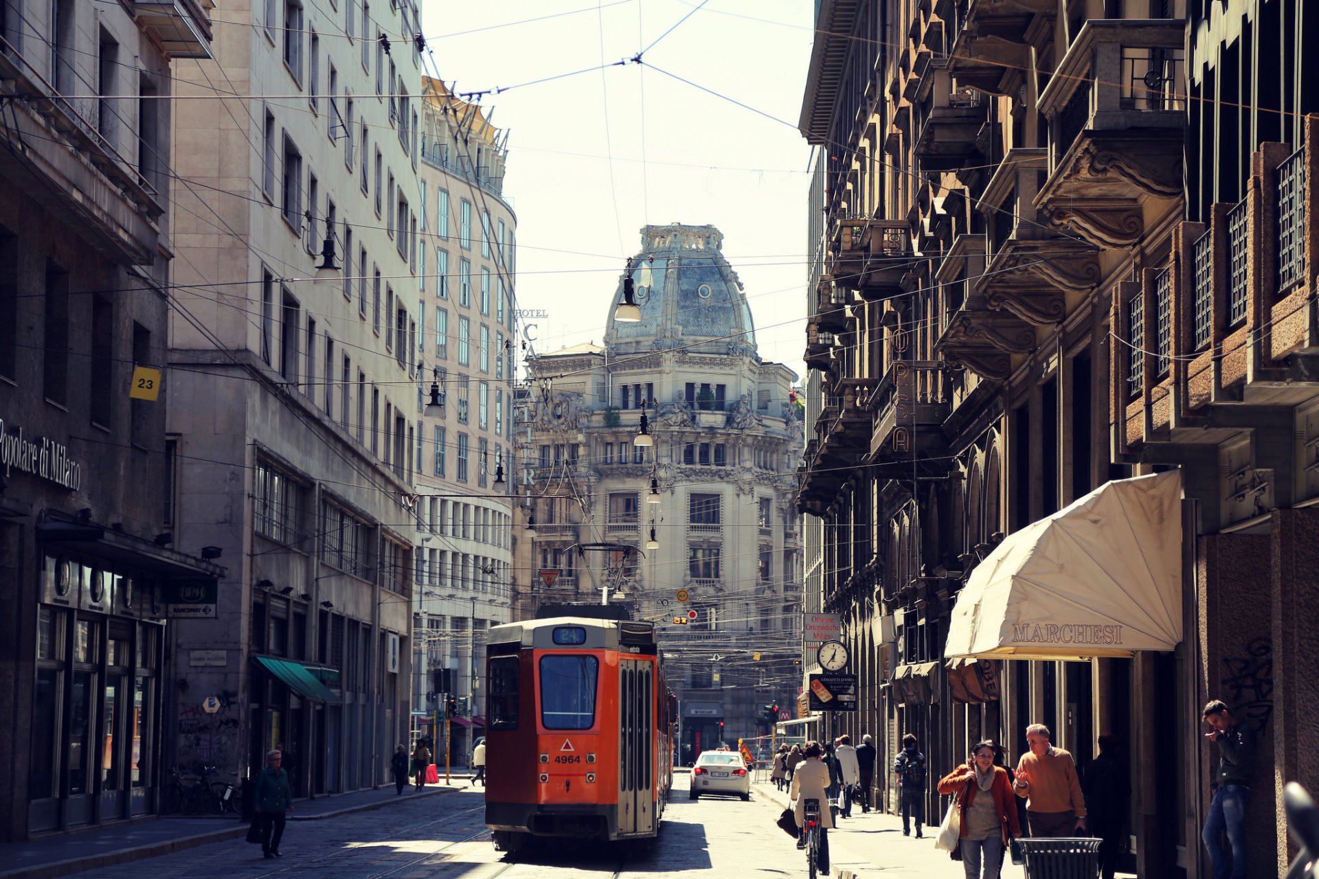 milan italy city street tram cars people road houses buildings architecture