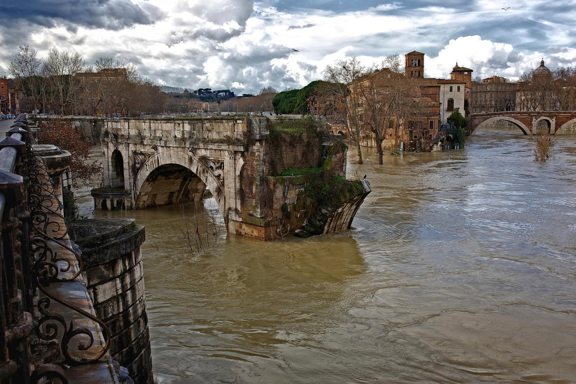 rome italy water flows ruins the old ancient roman bridge tiber