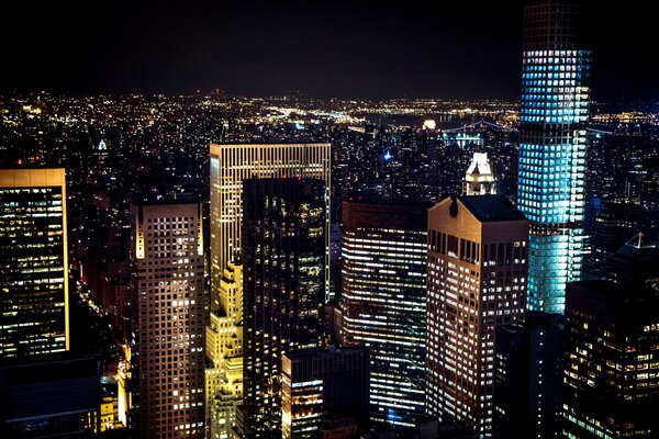 New York the light of fire in the night. Manhattan buildings , skyscrapers with illuminated skyscrapers. usa city of panoramic windows 