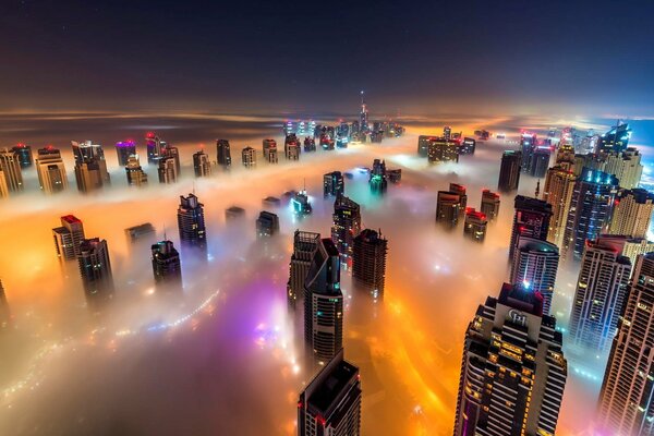 City high-rises in the night fog