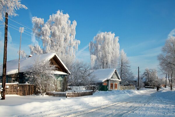 Old houses huts in the snow in the city of Russia