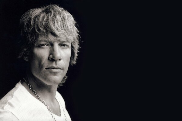 Portrait of musician Jon Bon Jovi on a dark background