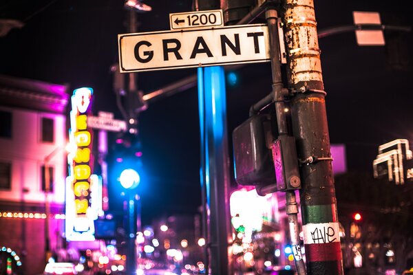 A signpost in the night city on the street