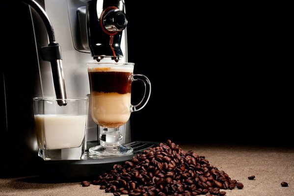 Coffee beans on the background of a glass of milk drink