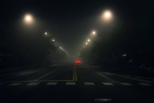 A passing car in the night mist