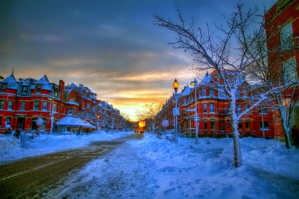 A street covered with snow with lanterns