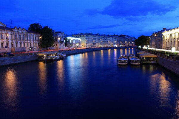 The lights of St. Petersburg at night are reflected in the river