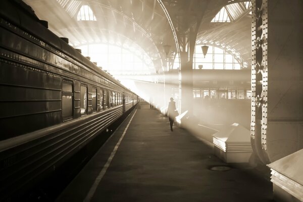 Morning train station gray train in the rays of the sun