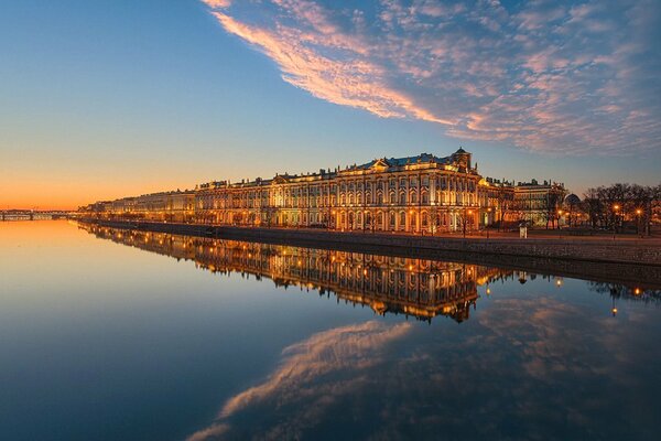 The water surface of the Neva embankment in the colors of the evening sunset