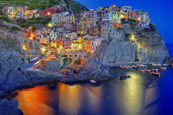 A small, beautiful, night town in Italy on the rocks