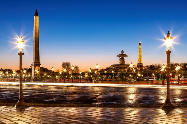 The lights of evening Paris illuminate the Eiffel Tower, the Place de la Concorde and the Luxor Obelisk