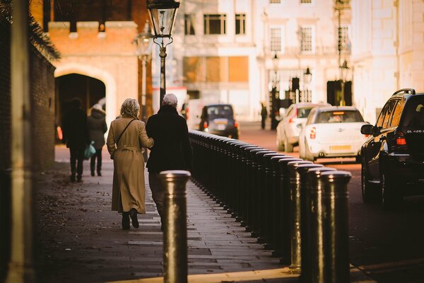 A couple walking down an autumn street