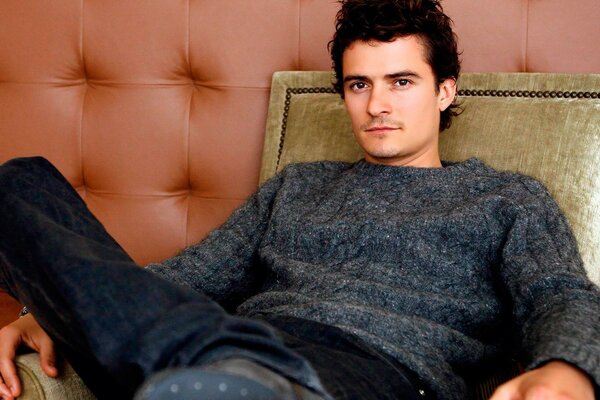 Actor Orlando Bloom in a chair. The star of The Lord of the Rings 