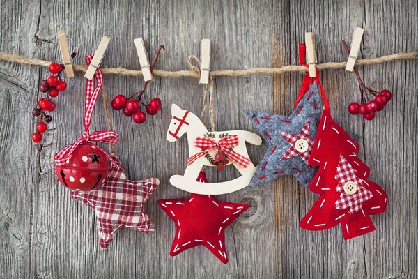 Fabric toys and twigs of berries on clothespins