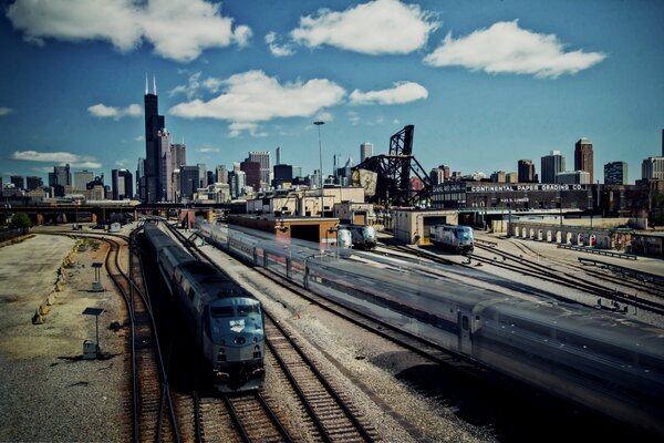 Trains on the railway against the backdrop of skyscrapers