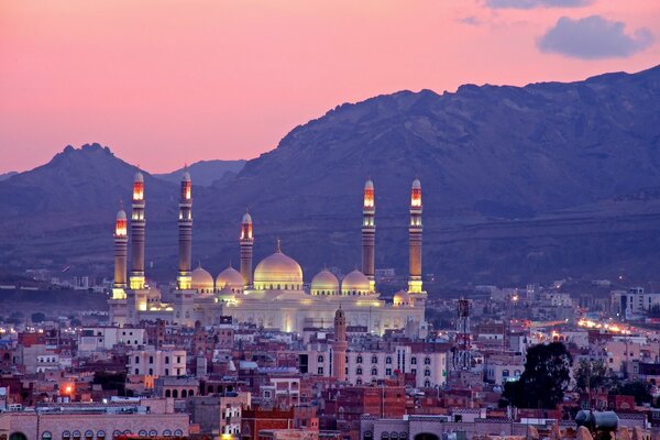 Al-Saleh Mosque against the backdrop of mountains and sunset