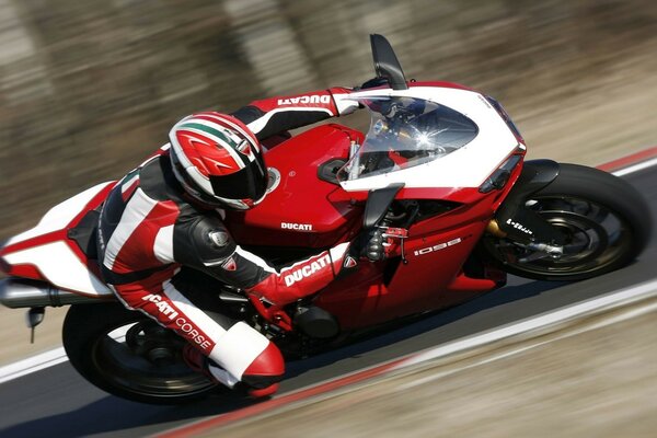 Motorcycle racer on a red ducati motorcycle