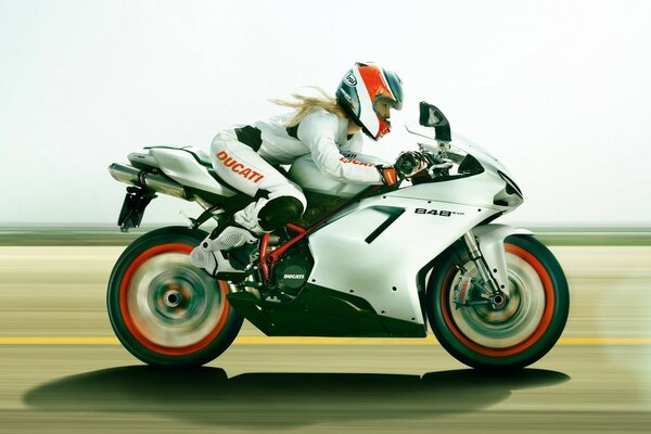 A girl on a white ducati 848 sports motorcycle