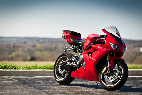 Red daytona 675 next to the road