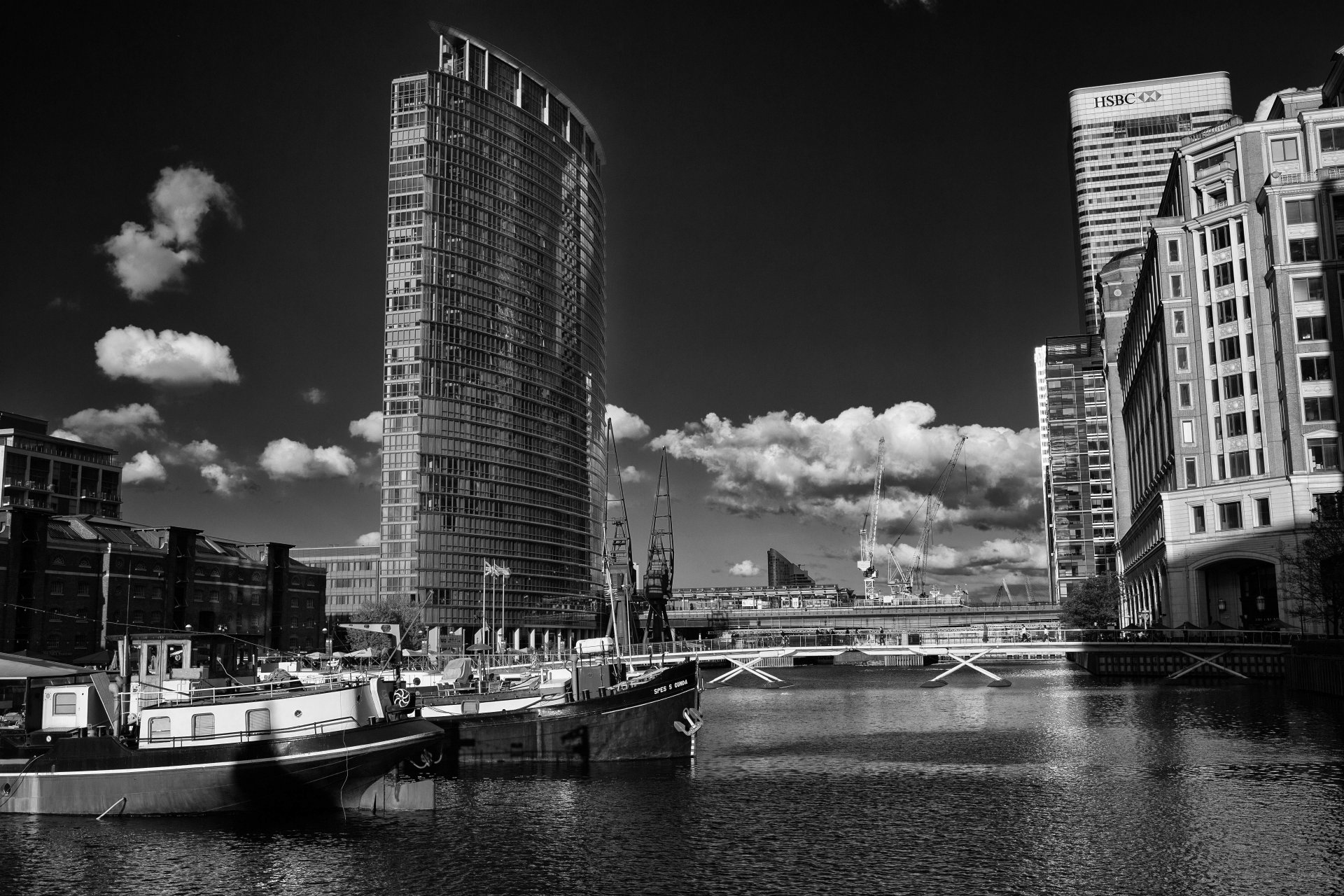 an francisco the wharf wharf water ships of the boat bridges buildings sky clouds black and white photo oboina