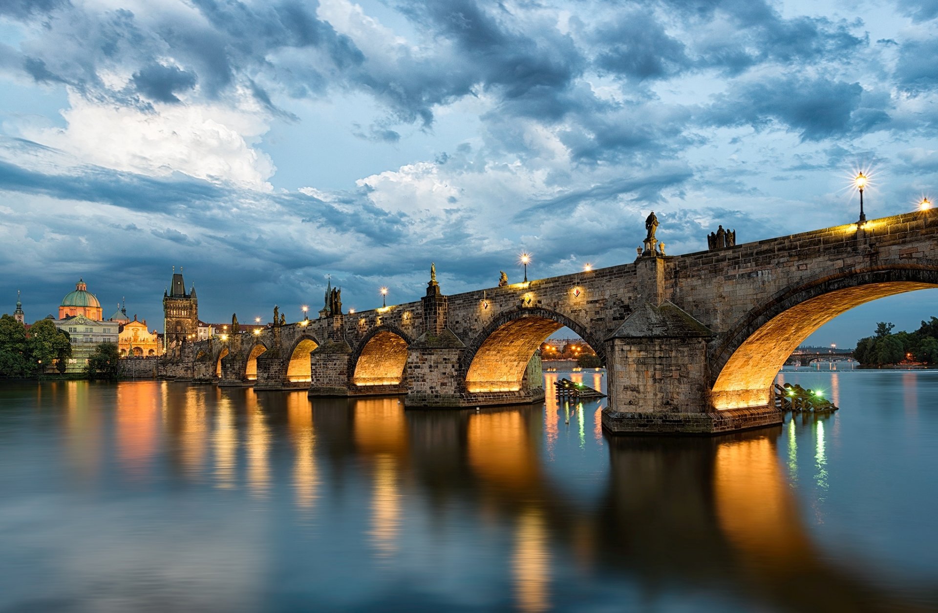 prague charles bridge karlów most czech republic czech republic česká republika city river vltava sky clouds water reflection evening lanterns lighting