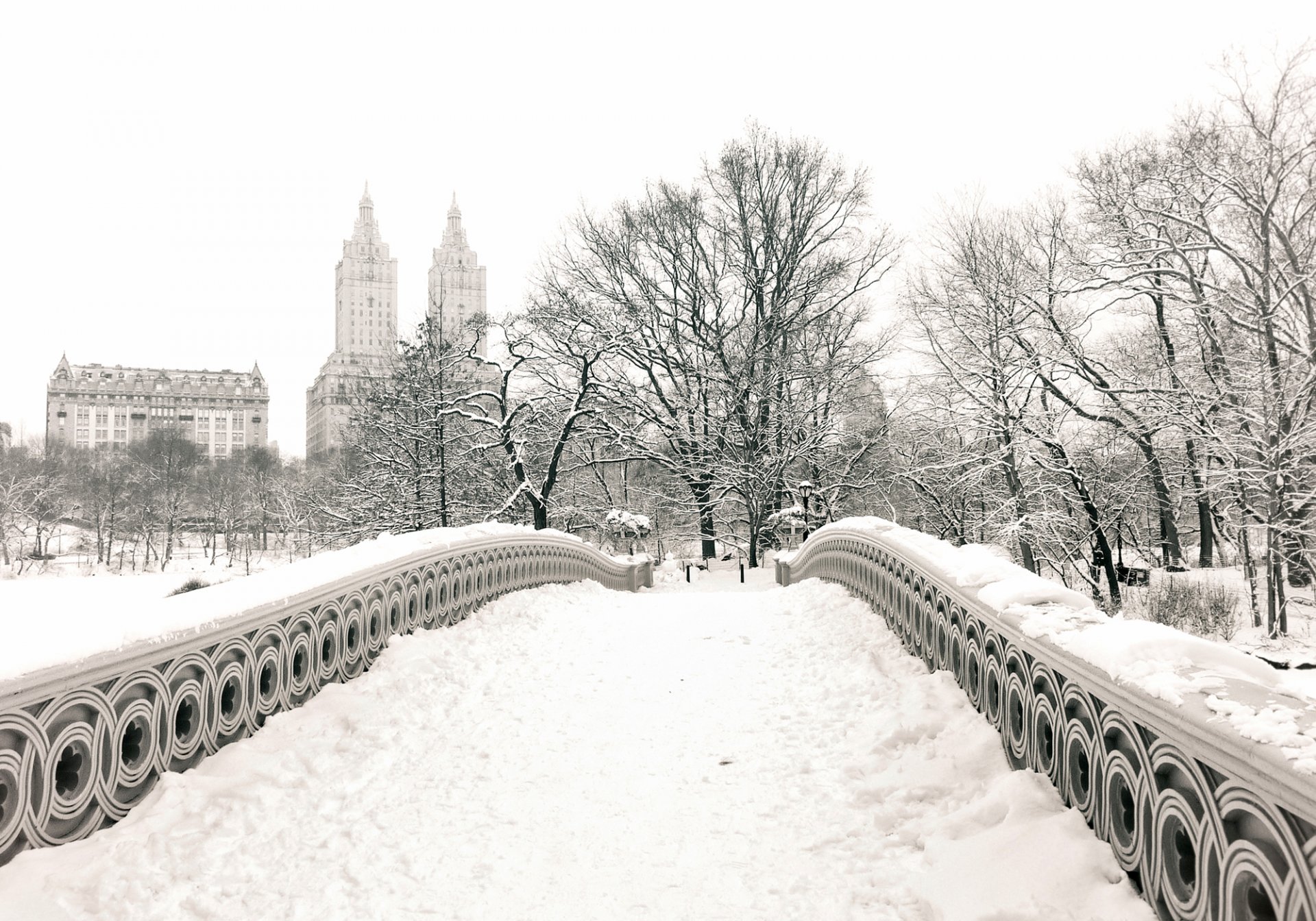 new york usa manhattan central park bow bridge city winter snow park trees buildings house