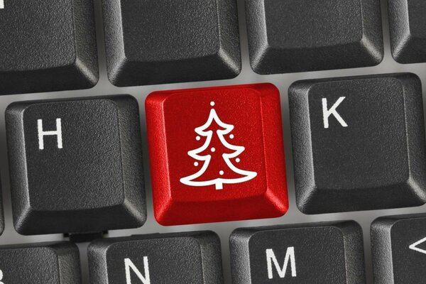 Tasto rosso-albero di Natale sulla tastiera del computer