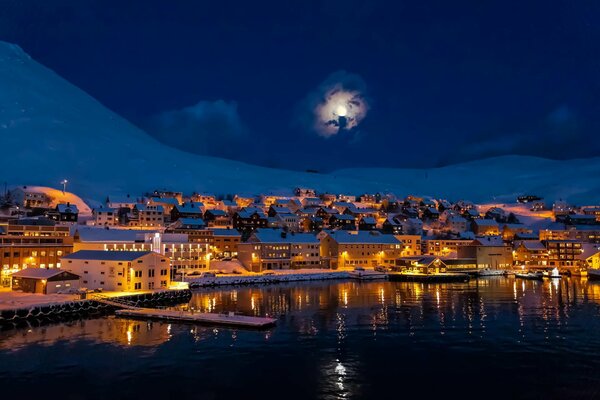 Snow-covered houses on the background of mountains