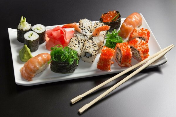 A portion of various sushi and rolls ready to eat