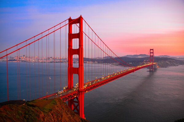 Ponte rosso sul fiume al tramonto