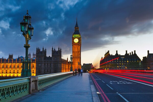 Big Ben in London at night with other buildings