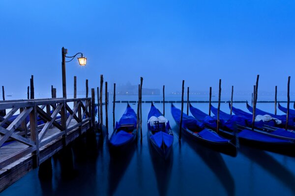 Venice in the fog of a gondola under a lantern