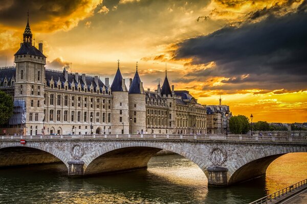Zamek La Conciergerie w Paryżu o zachodzie słońca