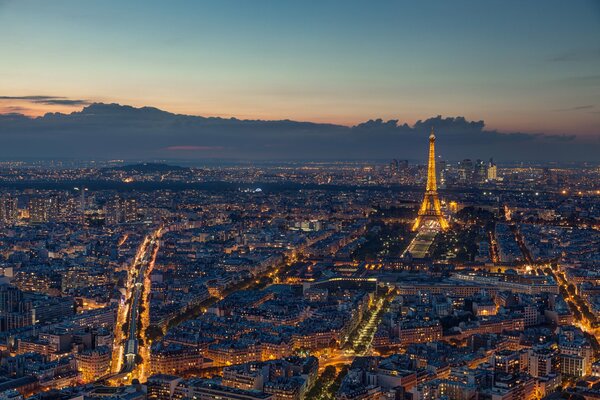 Eiffel Tower in the light of the evening city