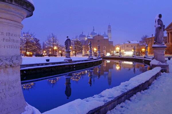 Snow-covered sculptures on the background of the cathedral