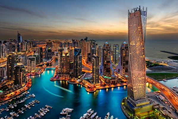 Dubai skyscrapers on the background of the sea at sunset