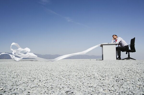 Office worker on the background of the desert