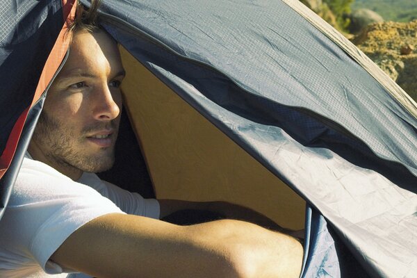 A man in a tent, outdoor recreation