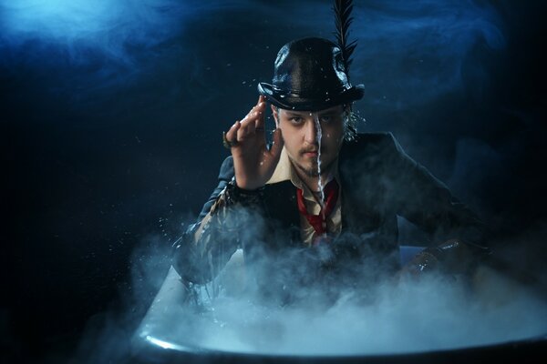 The hatter looks out of the blue fog