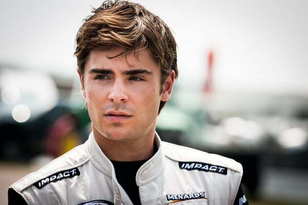 Handsome Zac Efron on a blurry background